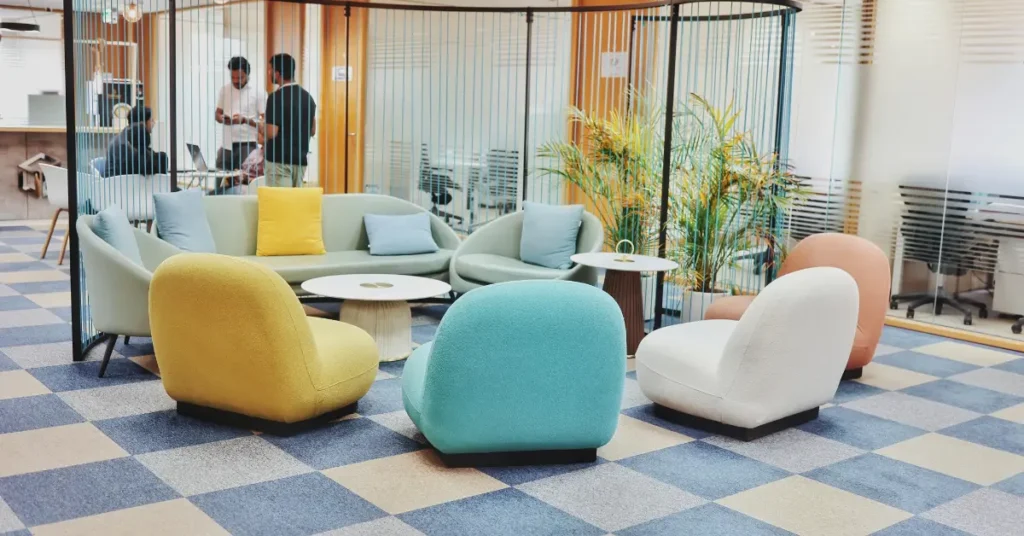 Vibrant coworking lounge in Dubai with modern seating, soft colors, and an open, collaborative atmosphere.
