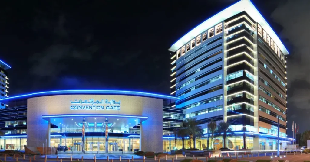 Exterior view of Dubai World Trade Centre’s Convention Gate building illuminated at night.